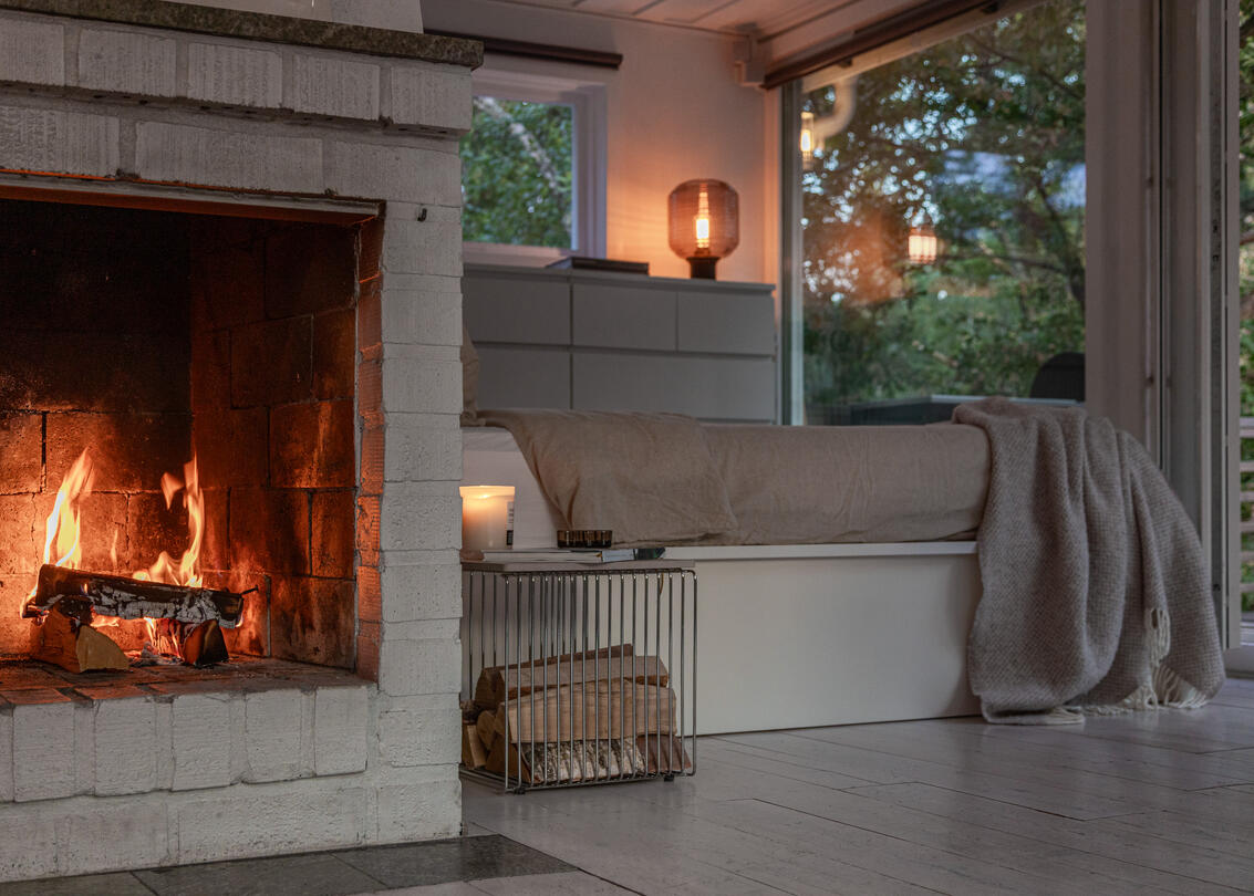 Lit fireplace and candles overlooking the forest at dusk. Lit fireplace and candles overlooking the forest at dusk.